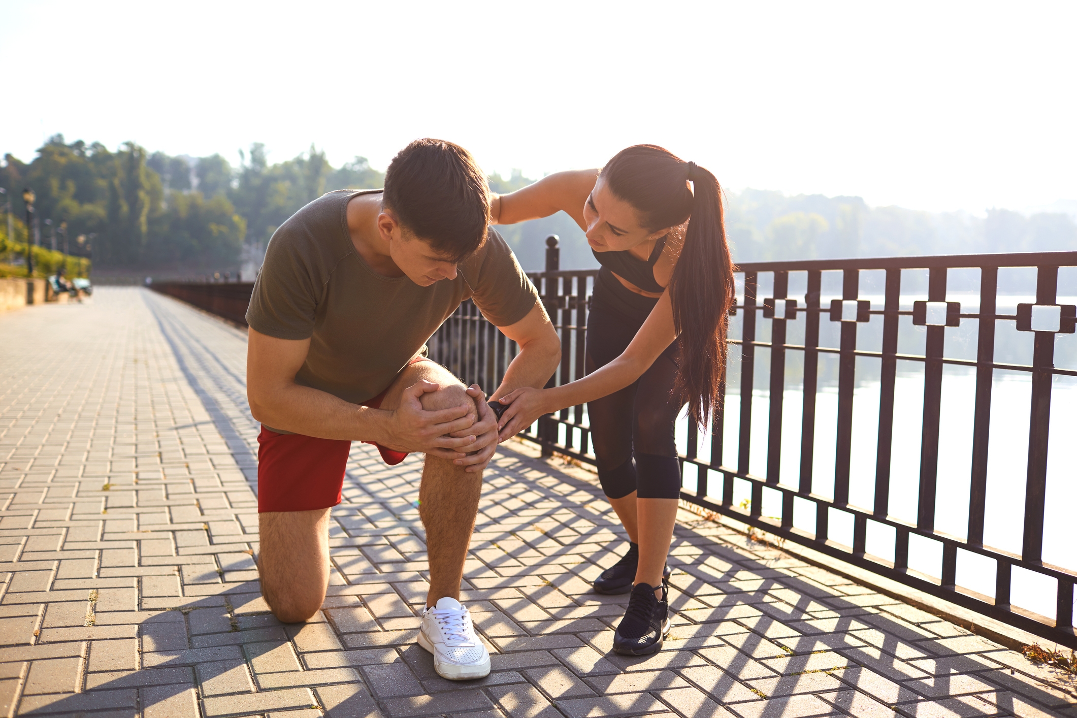 Woman helping a man with orthopedic injury outside