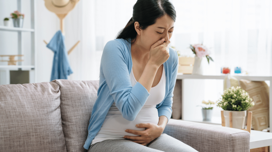 Woman experiencing morning sickness symptoms