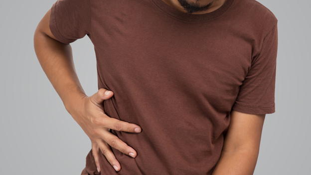 Man clutching his ribs due to intercostal muscle strain