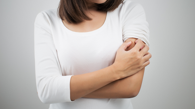 Woman itching her arm due to skin fungus