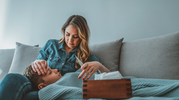 A mother comforting her son suffering from hand, foot, and mouth disease