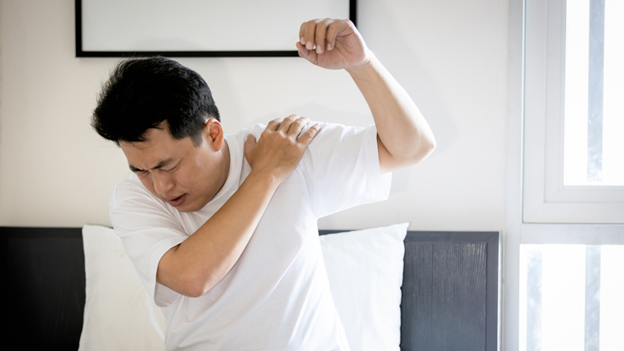 Man with frozen shoulder experiencing limited shoulder mobility