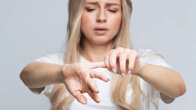 Woman experiencing pain from a dislocated finger