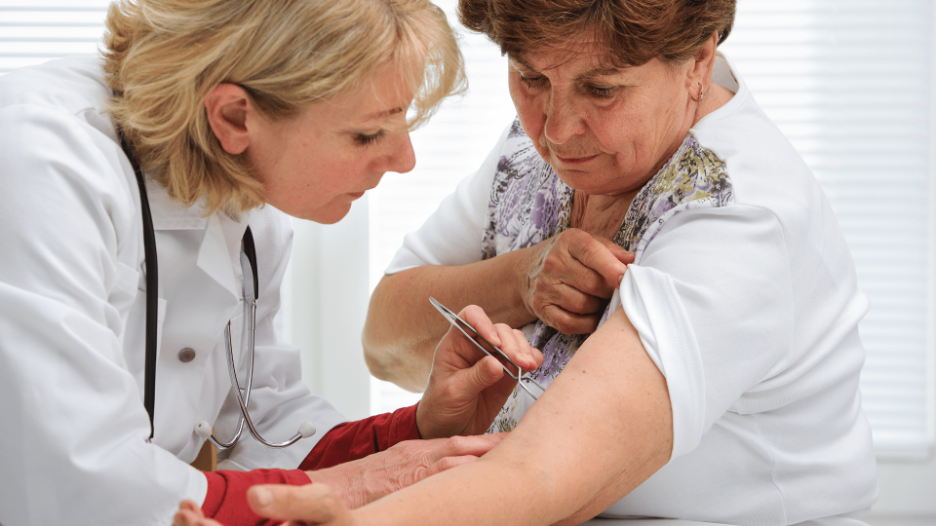 A CityMD doctor in New York removing a tick from a woman’s arm