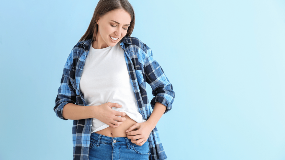 A woman scratching a rash on her stomach