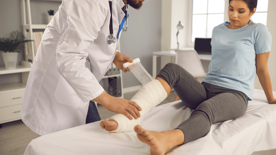 Doctor applying a cast to a patient's leg for stress fracture treatment at a CityMD urgent care clinic