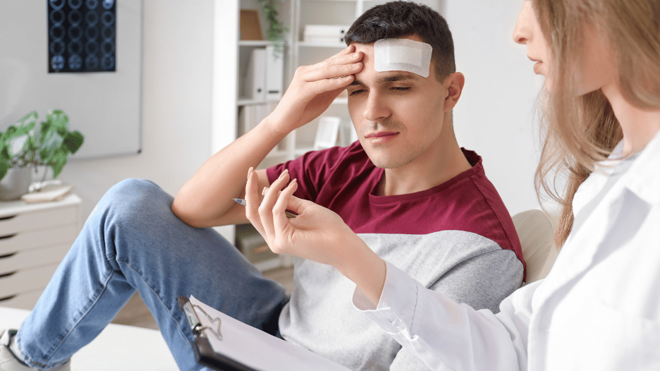 Patient with a head injury being examined by a doctor, illustrating symptoms of a concussion and the importance of seeking medical attention at CityMD