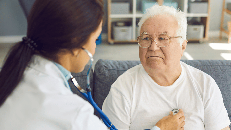 CityMD doctor examining elderly patient for walking pneumonia symptoms with a stethoscope