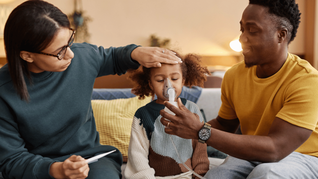 Young girl with contagious RSV being helped by her parents