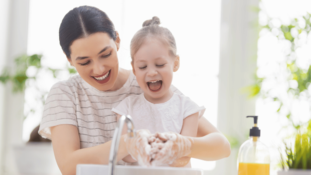 Mother and daughter washing hands to avoid getting sick in the winter