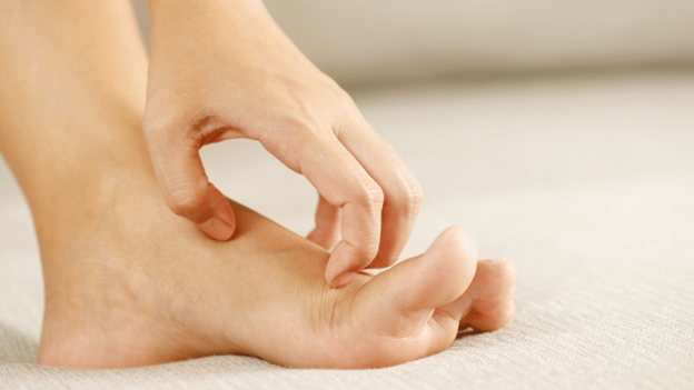 Person itching a skin fungal infection like athlete’s foot